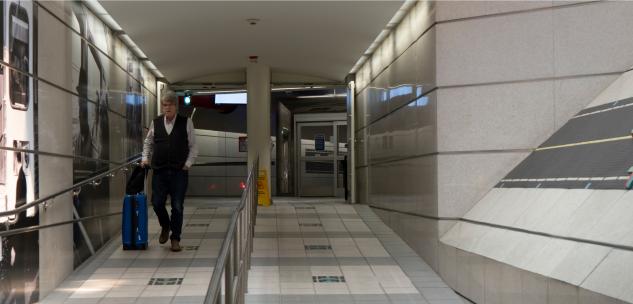 man walking towards the airport from the rta station